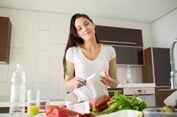 Young Woman Cooking in the kitchen. Healthy Food - Vegetable Salad. Diet. Dieting Concept. Healthy Lifestyle. Cooking At Home. Prepare Food Young Woman Cooking in the kitchen. Healthy Food - Vegetable Salad. Diet. Dieting Concept. Healthy Lifestyle. Cooking At Home. Prepare Food